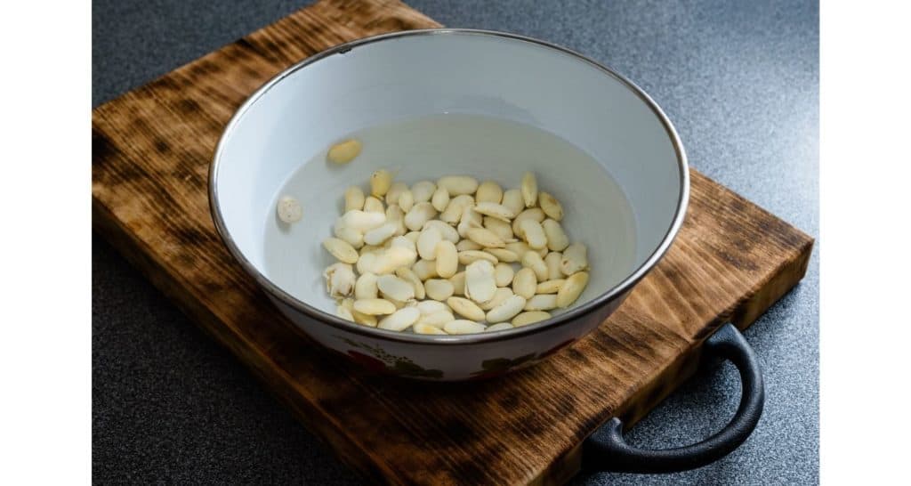 Soaking large white beans in bowl of water